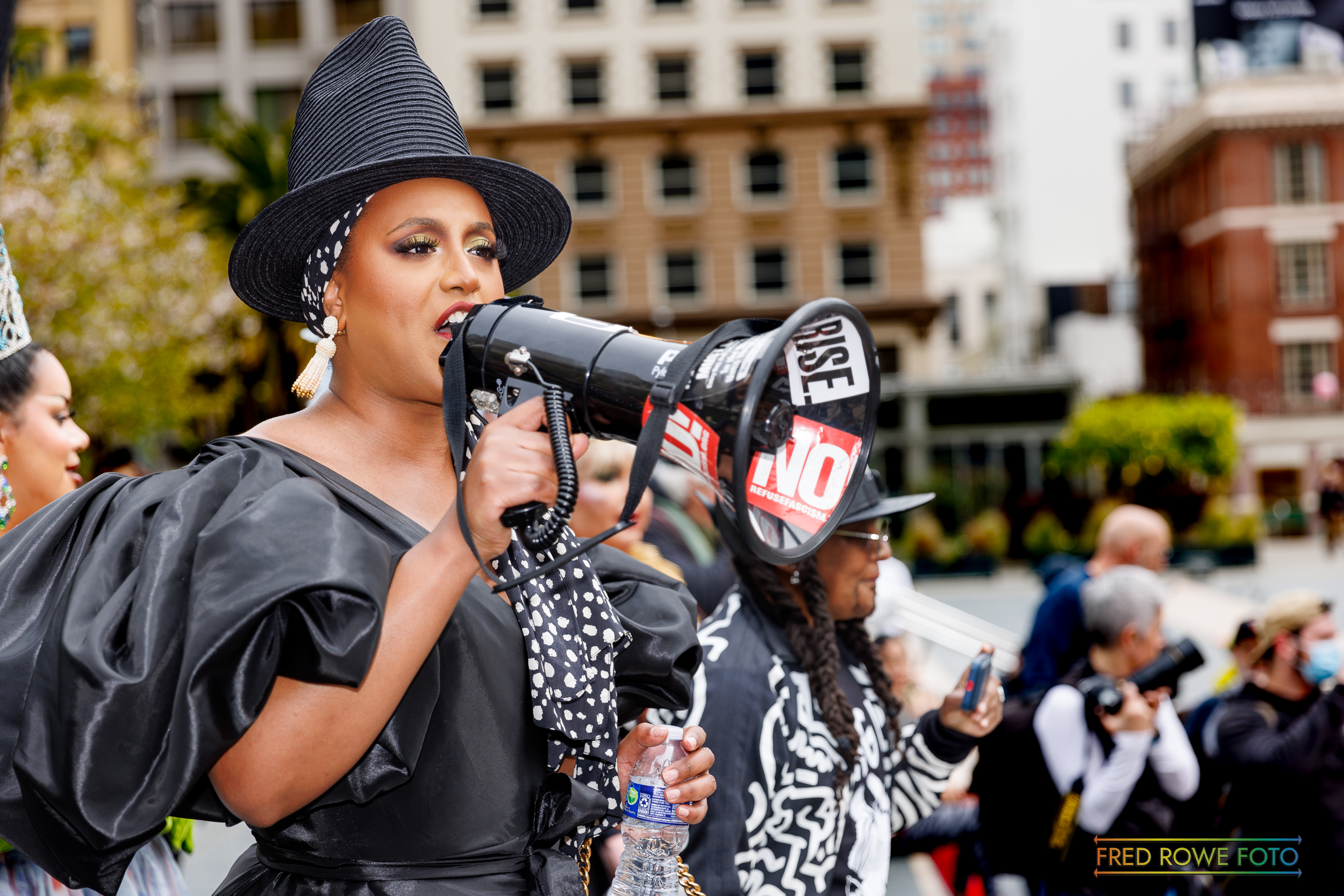 A protestor with a bullhorn at Drag Up! Fight Back!