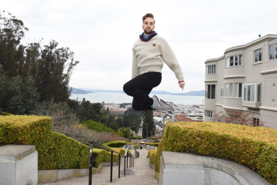 Queer dancer Myles Thatcher poses while jumping on top of Lombard Street in San Francisco.