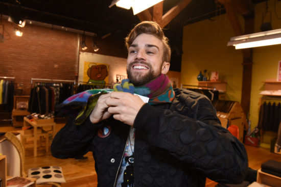 Myles Thatcher, a dancer for the San Francisco Ballet, tries on a colorful scarf at MAC in Hayes Valley.