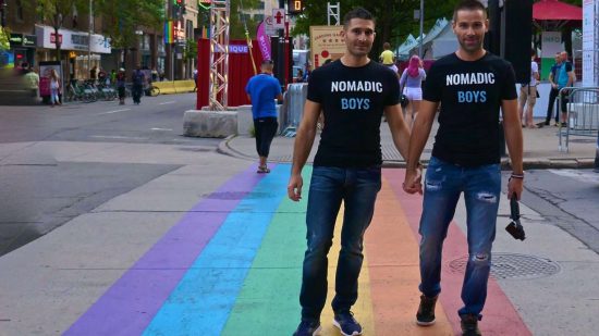 Gay couple Rainbow Crossing in Montreal