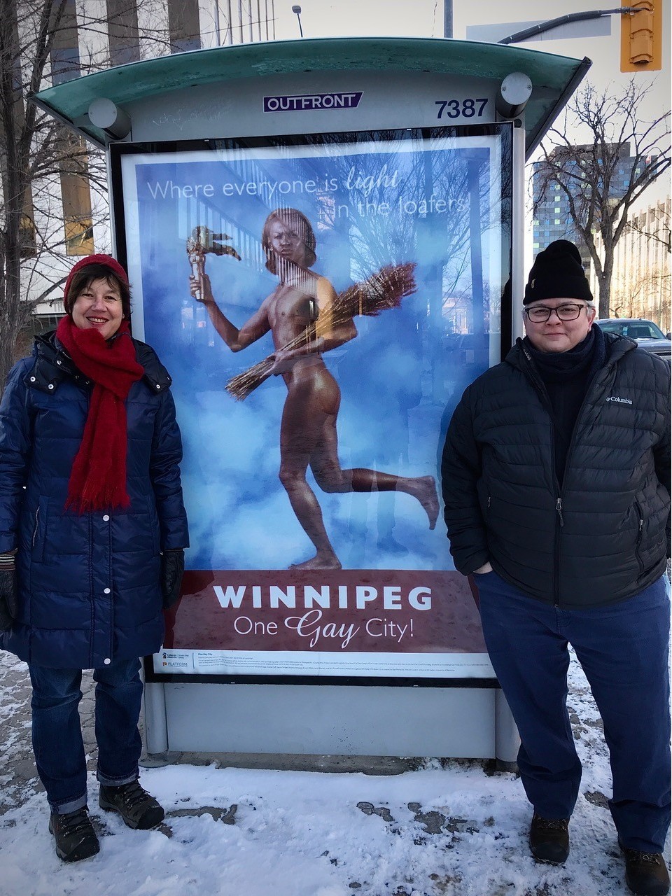Artists Shawna Dempsey and Lorri Millan besides one of their Winnipeg posters