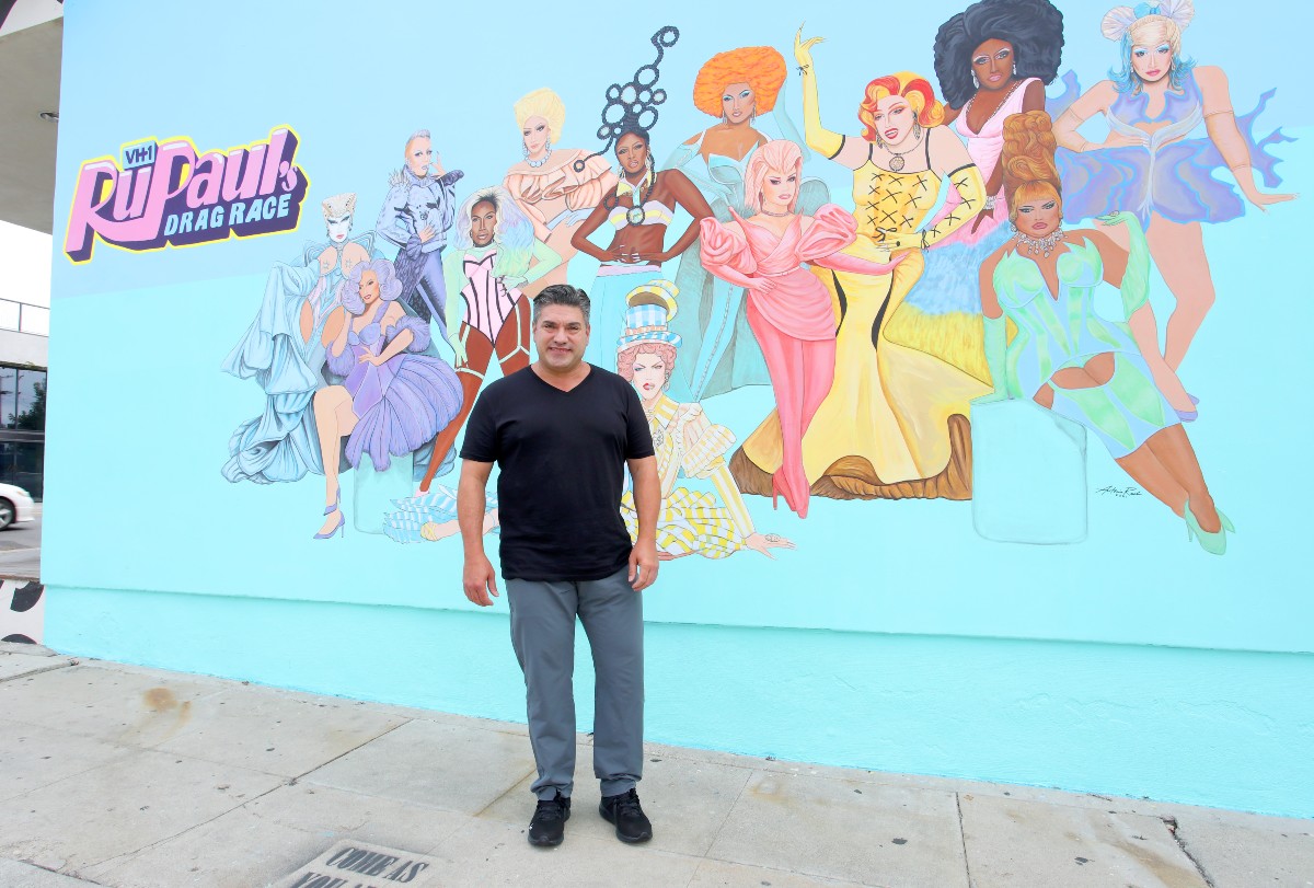Artist Antonio Rael in front of his Drag Race mural