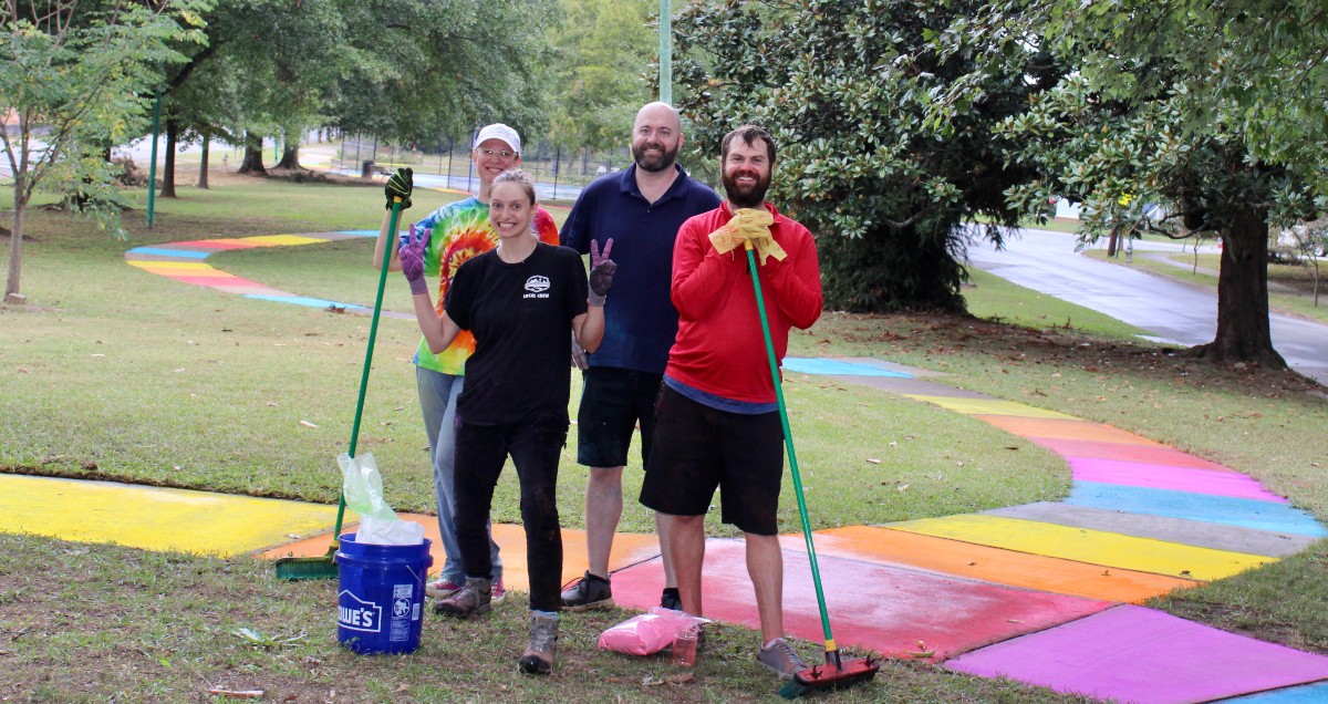 Matthew Terrell (right) and helpers create the Atlanta rainbow path